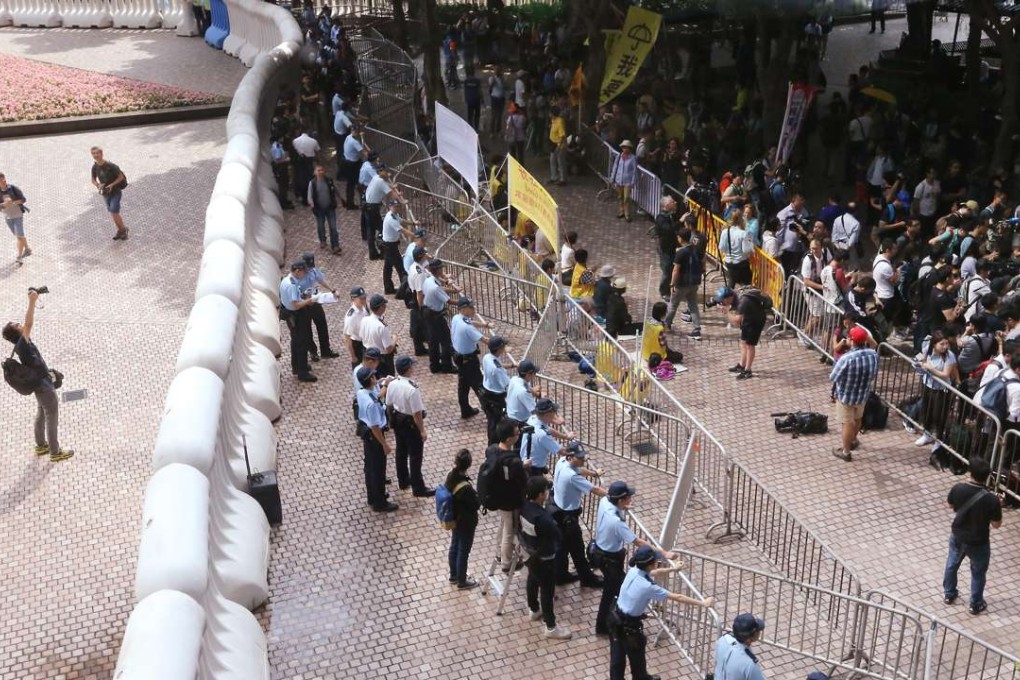 Pro-democracy protesters gather outside Central Plaza as Zhang Dejiang gave a keynote speech during his three-day visit to Hong Kong. Photo: Felix Wong