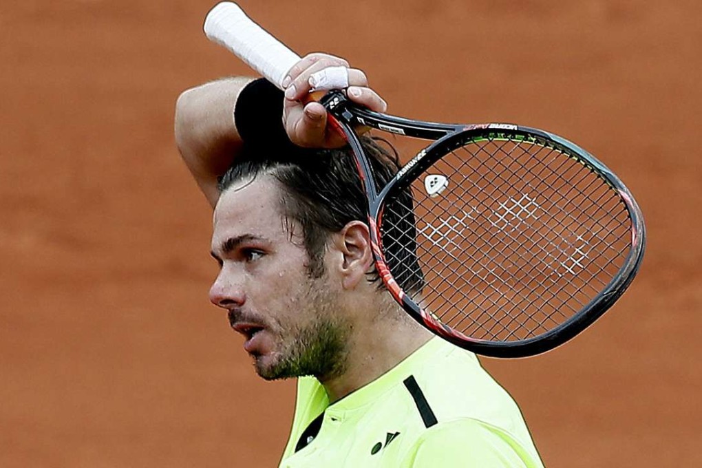 Stan Wawrinka of Switzerland had to fight hard to avoid becoming the first defending champion to lose in the first round at the French Open. He struggled to a five-set win over Lukas Rosol of the Czech Republic. Photo: EPA