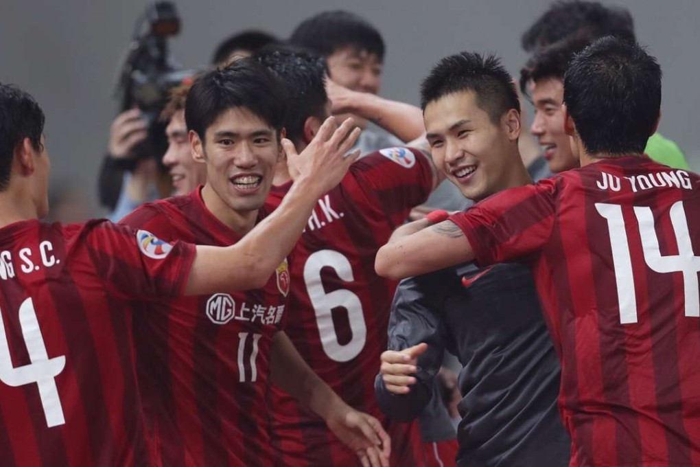 Shanghai SIPG players celebrate after advancing to the quarter-finals of the AFC Champions Legaue. Photo: Xinhua