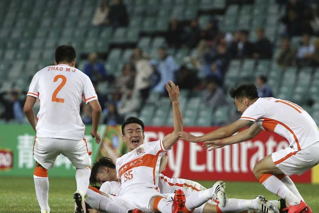 Shandong Luneng’s Dai Lin (centre) celebrates with teammates after scoring against Sydney FC during their AFC Champions League match in Sydney. Photo: AP