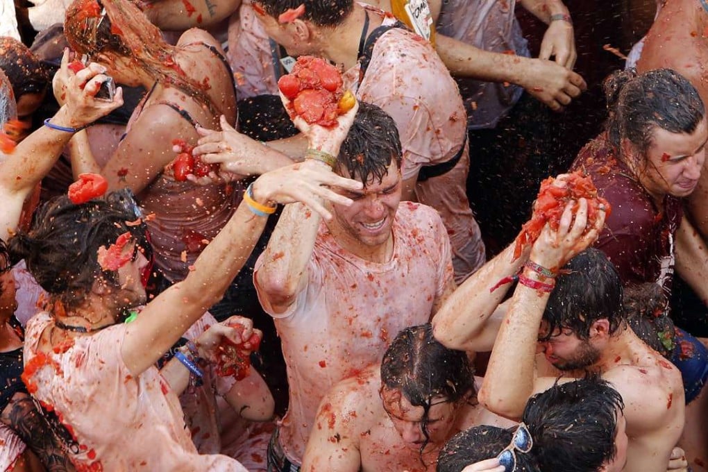 Crowds of people throw tomatoes at each other during the annual Tomatina tomato fight in the village of Bunol in Spain last August. Photo: AP
