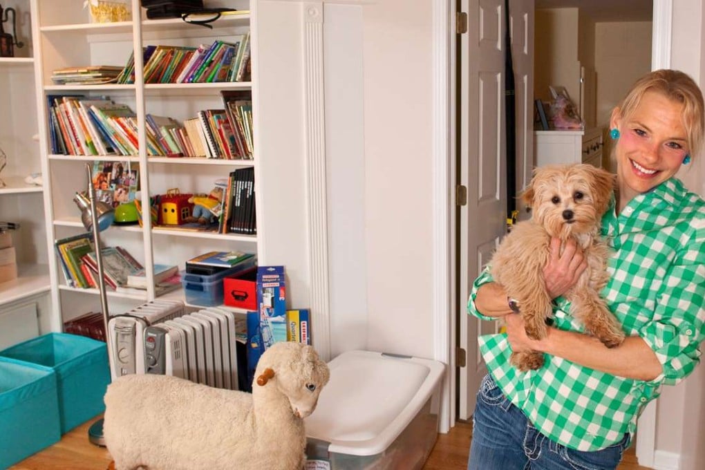 Meghan Kennihan with her dog, Maddie, in the finished basement of her parent’s home in La Grange, Illinois, where, as a millennial, she lives with her parents. Photo: TNS