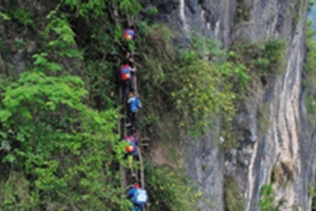 Villagers climb makeshift rattan staircases to get to their houses in Zhaojue county, Sichuan province. Photo: SCMP Pictures
