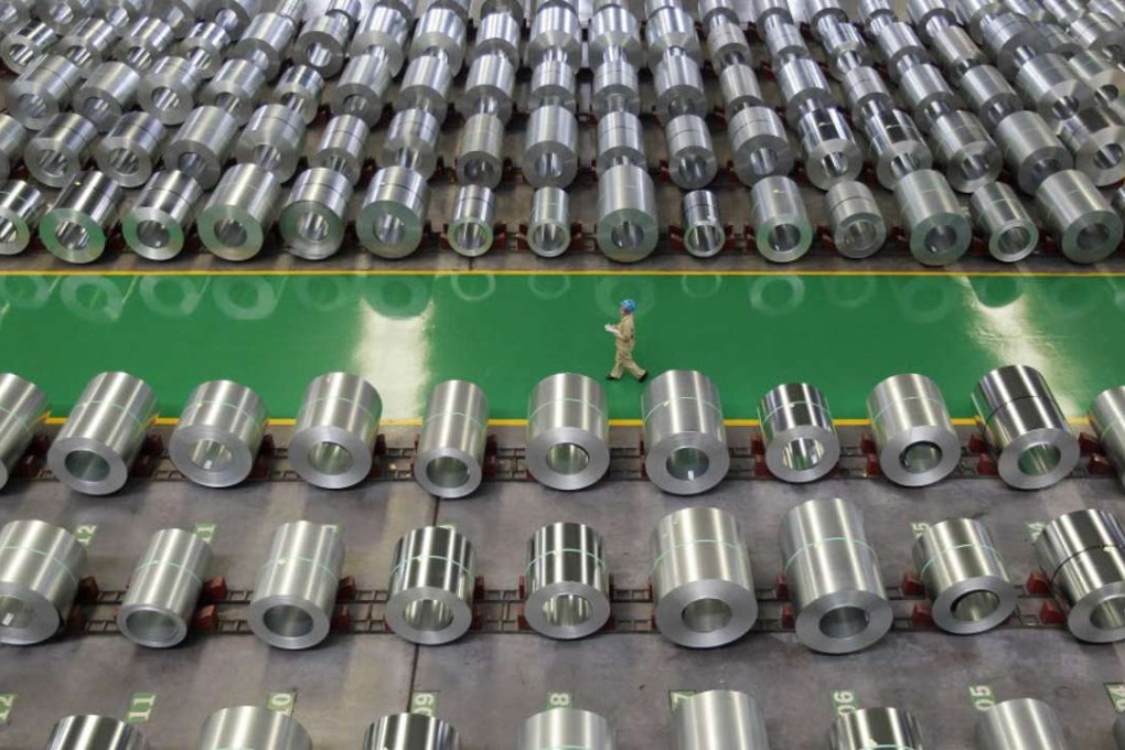 An employee walks past columns of steel at a steel production factory in Wuhan, Hubei province, China. Photo: Reuters
