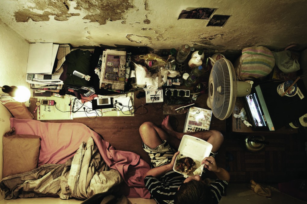 Life in a tiny cubicle that passes for a home in Hong Kong. Photo: Benny Lam