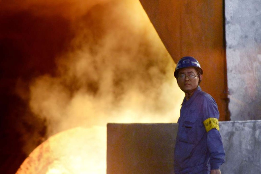 A worker looks on in front of a furnace in the Han-steel plant in Handan, in China's northern Hebei province. Photo; AFP , Wang Zhao