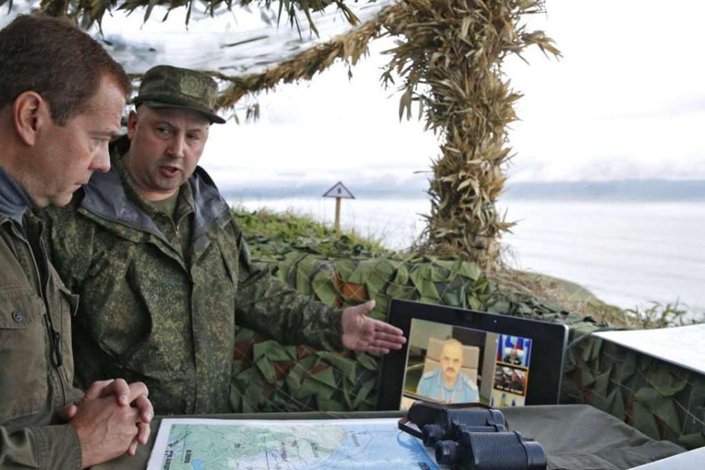 Russian Prime Minister Dmitry Medvedev (left) visits a machine gun regiment on Iturup island, one of four islands in the chain that lies off Russia’s far eastern coast and just north of Japan, on August 22, 2015. Photo: AFP
