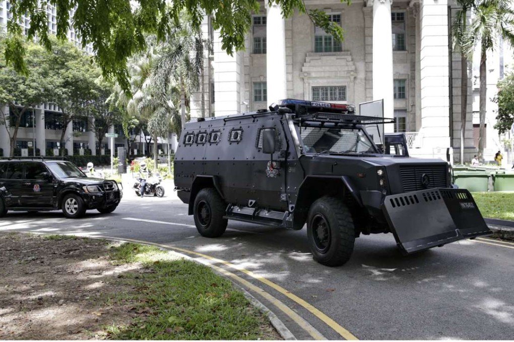 One of three armoured personnel carriers (front) from the Singapore police task force escorting six arrested Bangladeshi guest workers arrives at the State court in Singapore on May 27, 2016. Photo: AFP