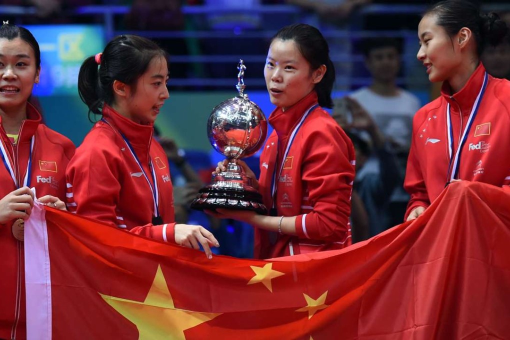 Li Xuerui (centre) holds the trophy China’s women won in the Uber Cup badminton tournament in Kunshan. Photo: AFP