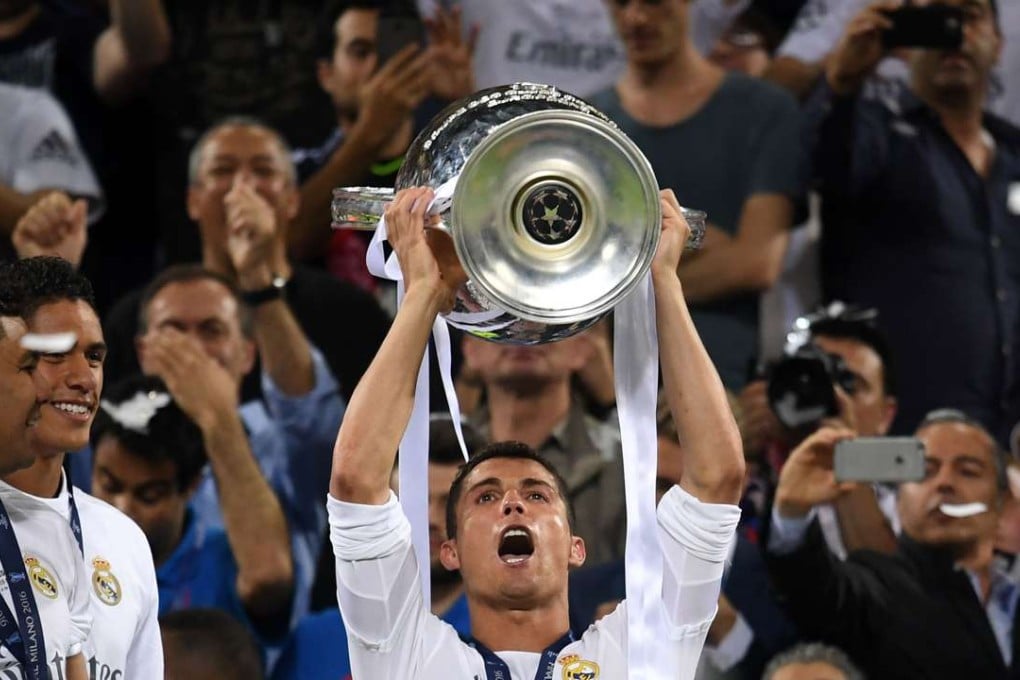 Cristiano Ronaldo raises the Champions League trophy as Real Madrid are crowned again. Photo: Xinhua