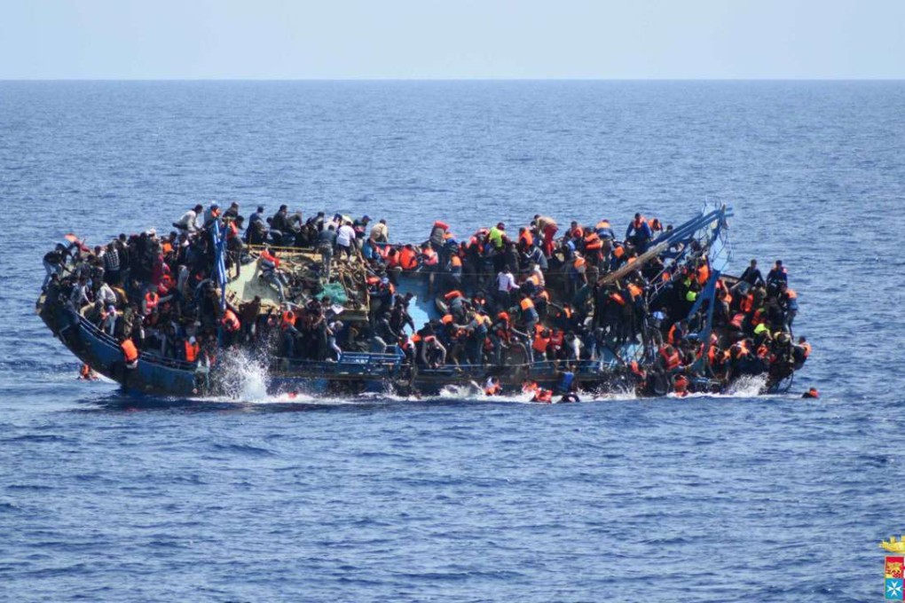 People try to jump in the water right before their boat overturns off the Libyan coast. Over 700 migrants are feared dead in three Mediterranean Sea shipwrecks south of Italy in the last few days as they tried desperately to reach Europe in unseaworthy smuggling boats. Photo: AP