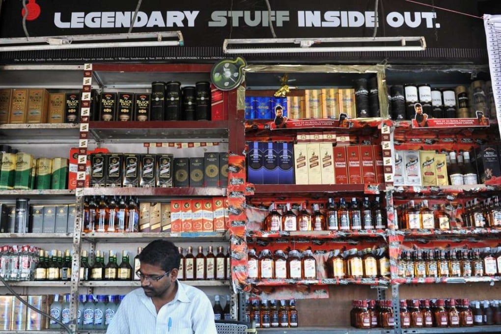 An employee takes stock at an alcohol shop in Hyderabad. Photo: AFP