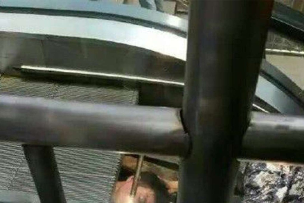 The workman trapped inside the escalator in Chongqing. Photo: SCMP Pictures