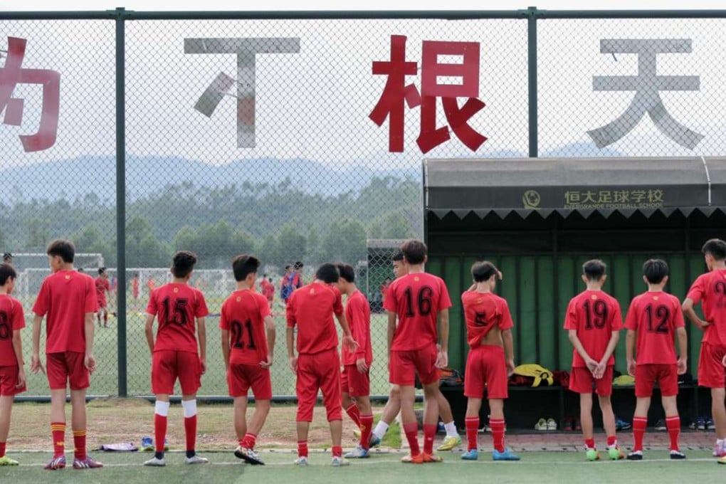 Evergrande Football School pupils take a break after a training session. Photo: Thomas Yau