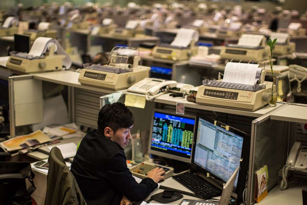 A trader works at the stock exchange in Hong Kong on April 9, 2015. Photo: AFP
