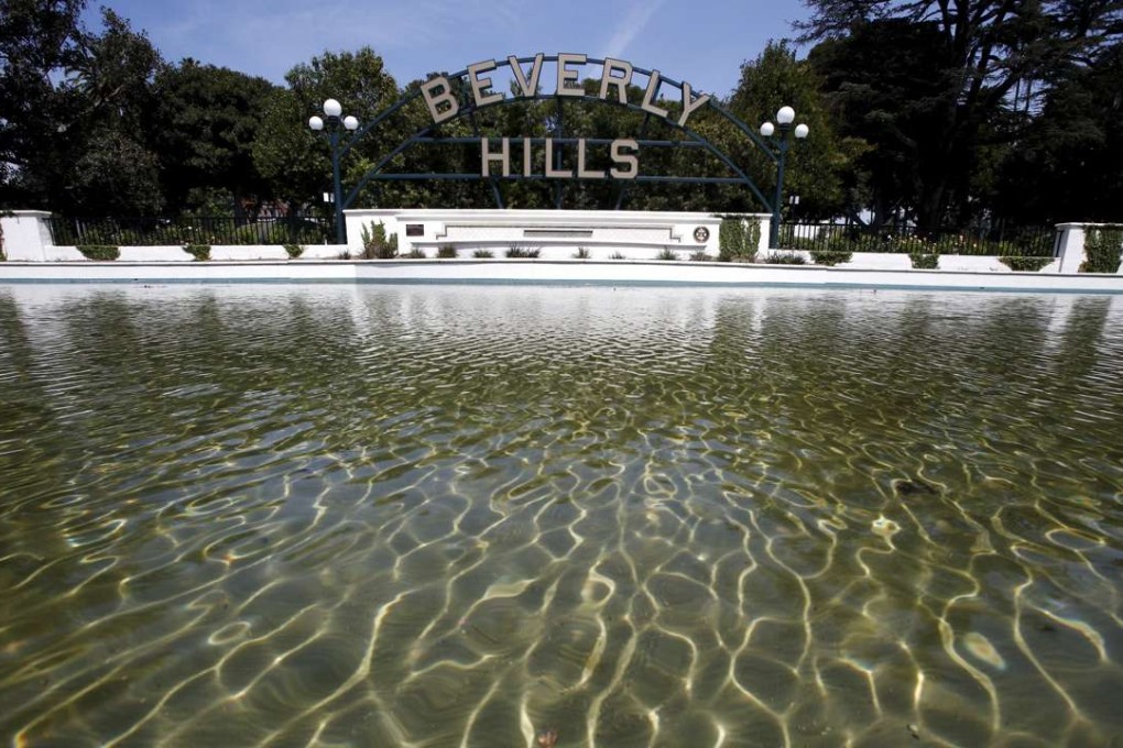 Water is seen in a pond in front of Beverly Hills' city sign, California, Photo; Reuters, Lucy Nicholson
