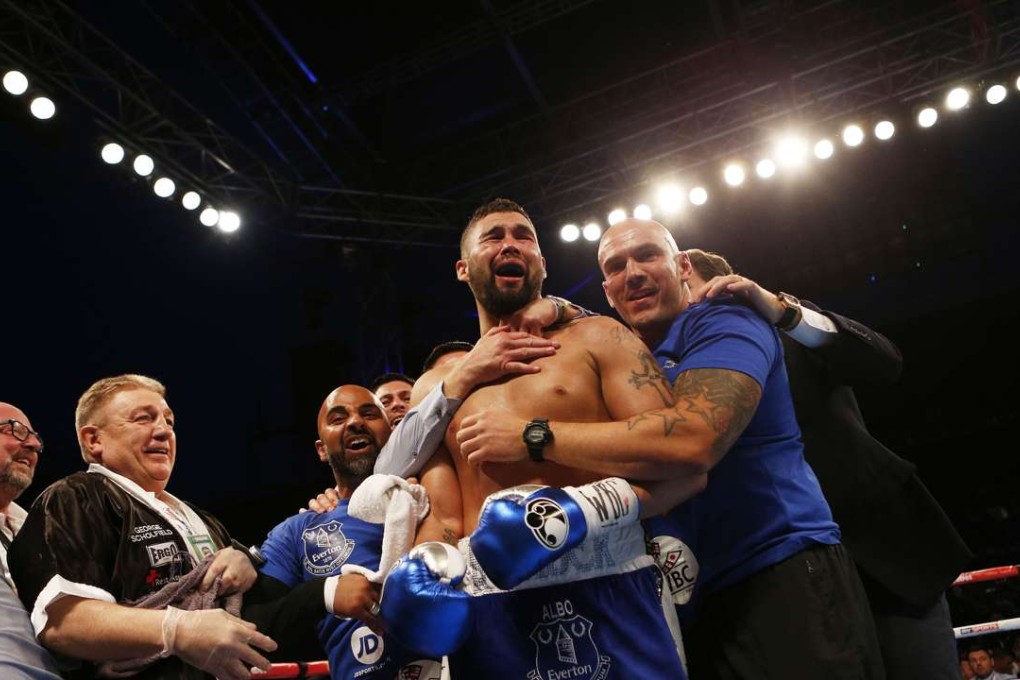 Tony Bellew celebrates winning a world title at the third attempt. Photo: Reuters