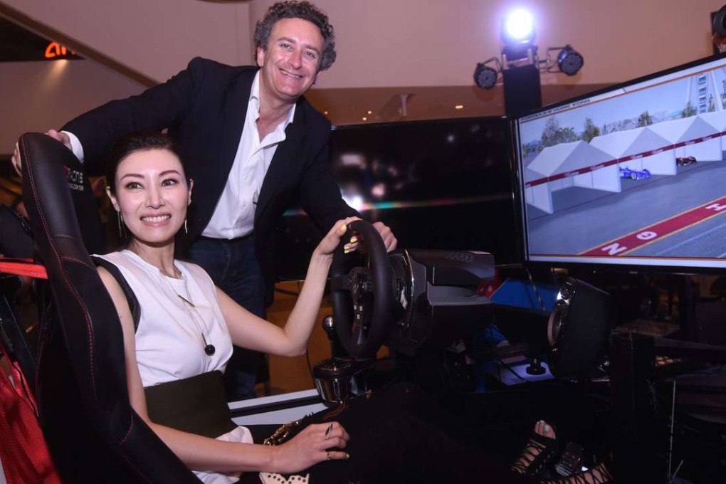 Formula E chief executive Alejandro Agag and former Miss Hong Kong Michele Reis get to grips with a Formula E simulator during promotion for the Hong Kong e-Prix. Photo: SCMP Pictures
