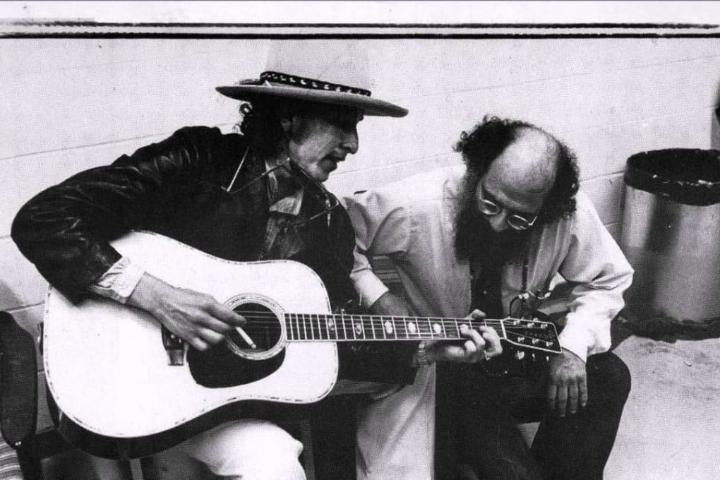 Allen Ginsberg gets a lesson in chord structure from Bob Dylan in this undated photo.