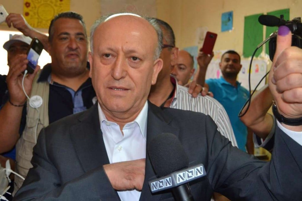 Sunni politician Ashraf Rifi shows his ink-stained thumb after casting his ballot at a polling station during Tripoli's municipal elections on Sunday. Photo: Reuters