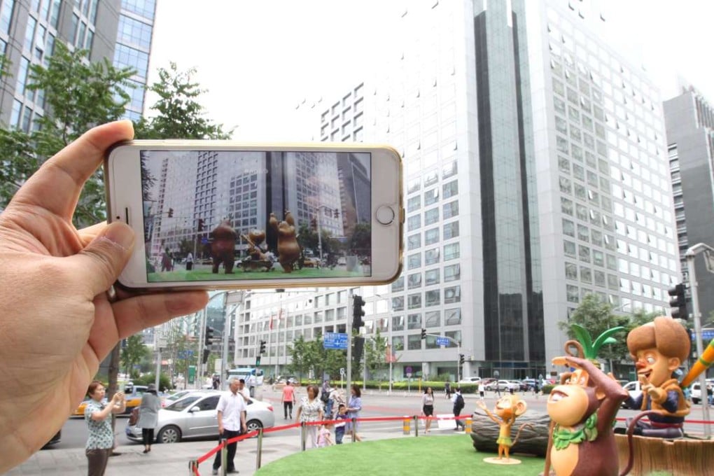 The two bear statues (seen in the mobile phone) in front of the China Securities Regulatory Commission headquarters in Beijing were replaced with that of two monkeys on Wednesday. Photo: Simon Song
