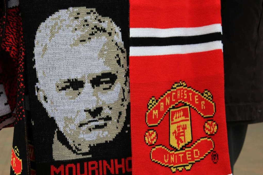 Scarves featuring the image of Manchester United's new manager Jose Mourinho are displayed for sale outside Old Trafford. Photo: AFP