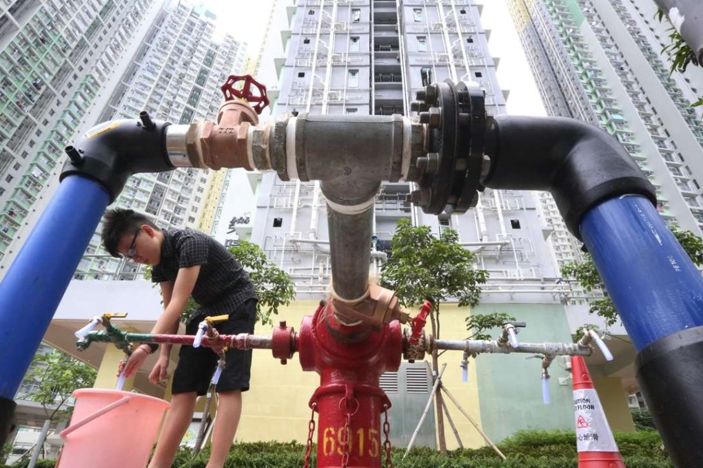 A resident of Kai Ching Estate in Kai Tak stocks up water from a fire hydrant after drinking water was found to be tainted with lead. Photo: Felix Wong