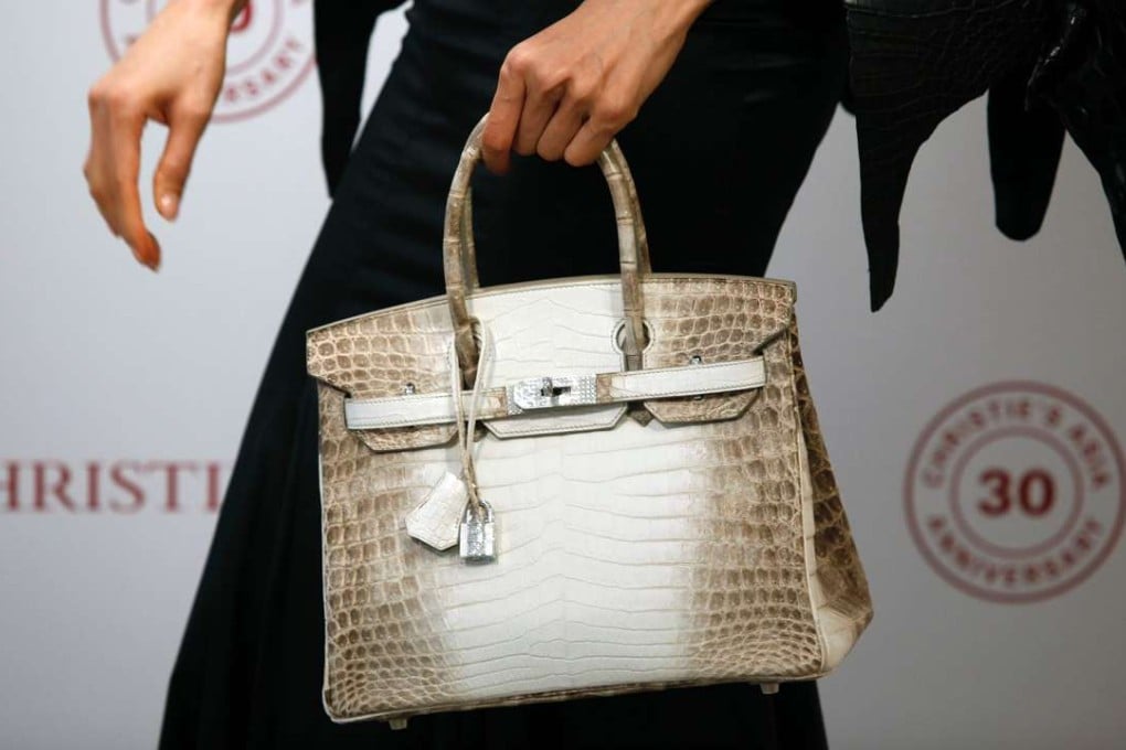 Eunis Chan shows the Matte White Himalaya Niloticus Crocodile Diamond Birkin with 18K gold and diamond hardware at a preview earlier this month. The bag sold for a record HK$2.33 million. Photo: AFP
