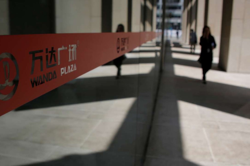 Pedestrians walk past Dalian Wanda Group's Wanda Plaza building in Beijing on May 17, 2016.Photo: Reuters