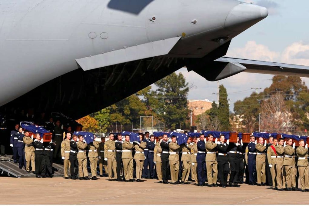 Australian Defence Force soldiers carry coffins containing the remains of 33 Australians who died in the Vietnam war. Photo: Reuters