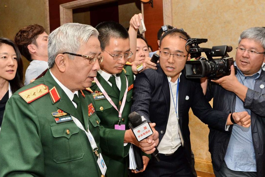 Vietnam's Deputy Defence Minister Nguyen Chi Vinh is surrounded by the media after a meeting Chinese officials on the sidelines of the Shangri-La Dialogue in Singapore on Friday. Photo: AFP