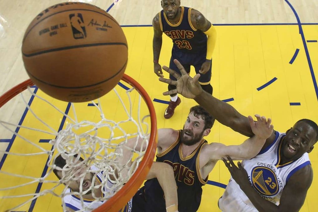 Golden State Warriors forward Draymond Green shoots over Cleveland Cavaliers forward Kevin Love during game one of the NBA Finals. Photo: AP