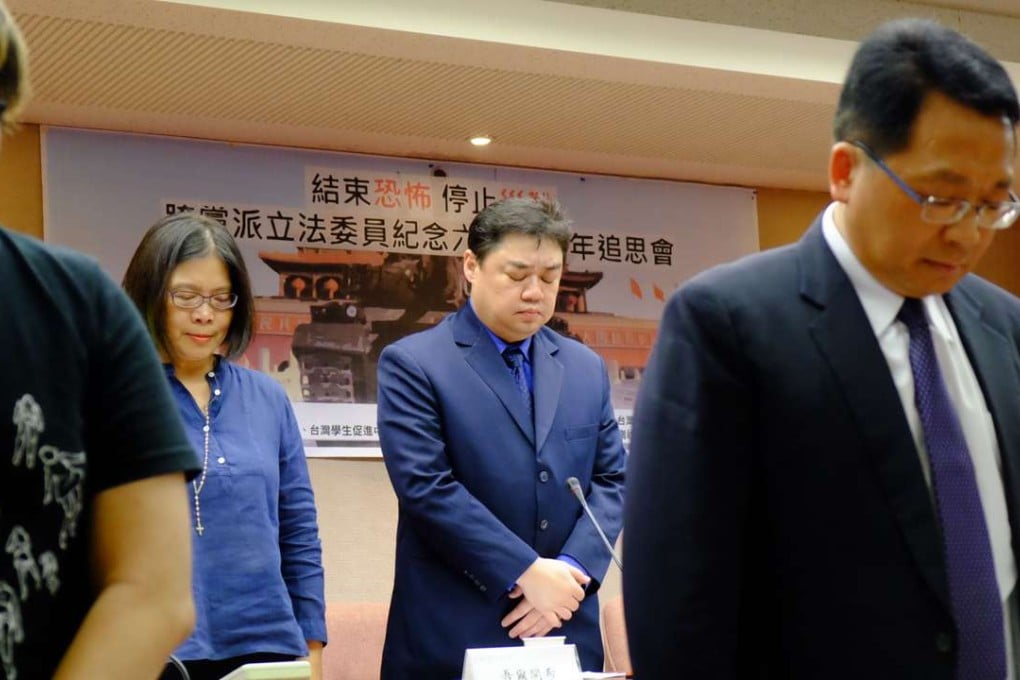 Chinese dissident Wuer Kaixi (second right), Taiwanese lawmakers and a human rights activist pay their respects at the parliament in Taipei on Friday on the eve of the 27th anniversary of the June 4 crackdown on pro-democracy protests at Beijing's Tiananmen Square. Photo: AFP