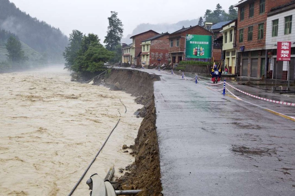 High water levels and strong currents have torn away the side of a river bank in Chongqing. Photo: Xinhua