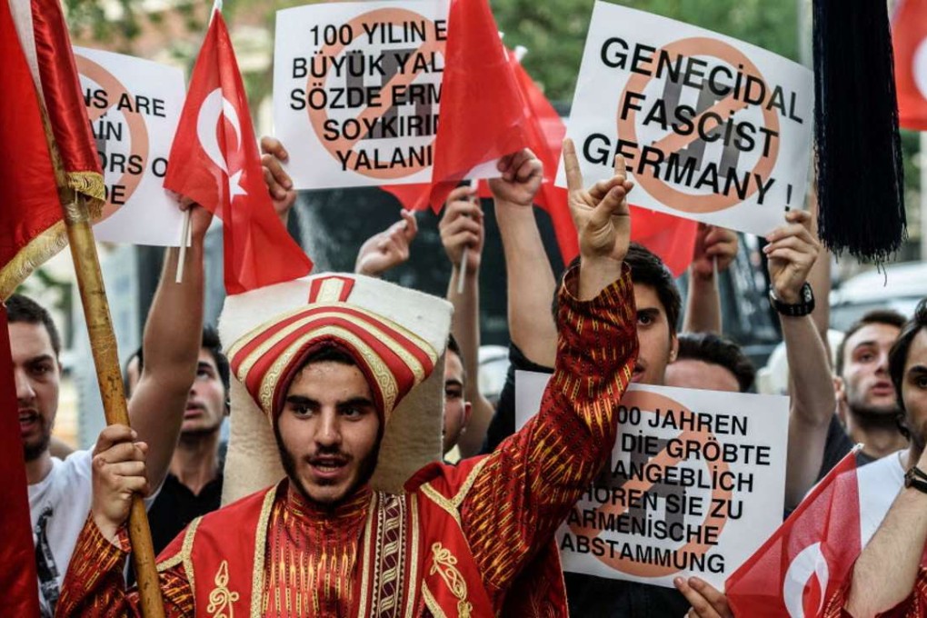 Turkish demonstrators flash the nationalist organisation’s “grey wolf”sign during a protest outside the German consulate in Istanbul on Thursday after German parliament labelled the World War I massacre of Armenians by Ottoman forces as genocide. Photo: AFP