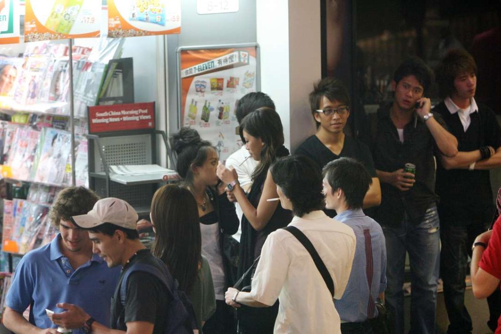 People drinking outside a 7-Eleven in Lan Kwai Fong.Photo: K. Y. Cheng