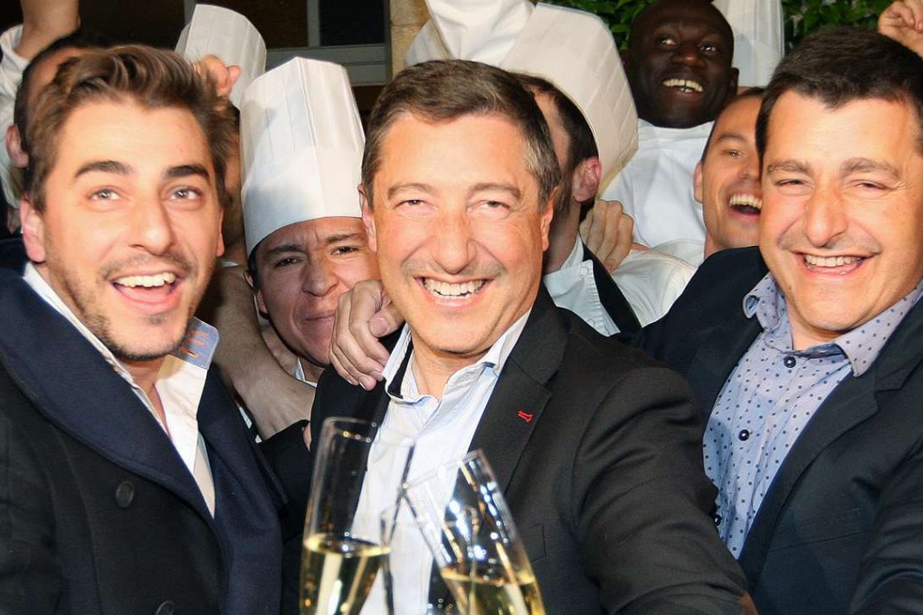 The Roca brothers Joan (centre), Jordi (left) and Josep celebrate with employees after their restaurant in Spain, El Celler de Can Roca, was named best in the world for the first time, in 2013. Joan and Jordi are in Hong Kong to cook an exclusive meal for customers of a credit card company. Photo: AFP