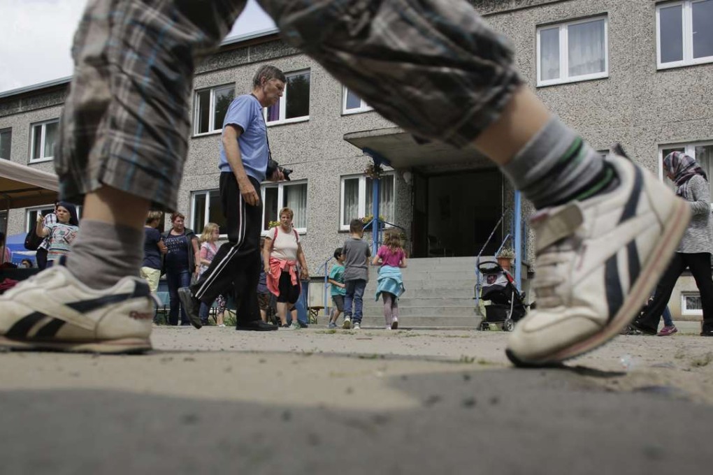 People attend a summer party at an accommodation for migrants where Halima Taha works as a translator. Photo: AP