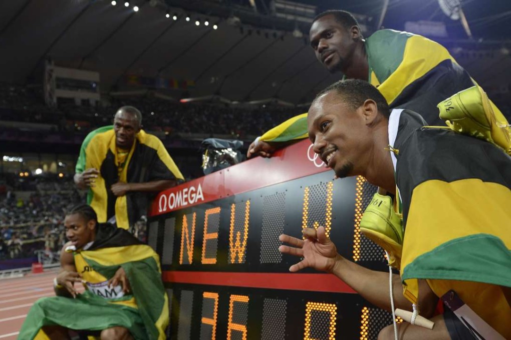 Clockwise from bottom left: Jamaica's Yohan Blake, Usain Bolt, Nesta Carter and Michael Frater pose by the record board after setting a new world record in the men's 4X100 relay final at the London Olympic Games in 2012. Jamaica also won gold in the same race in Beijing four years earlier. Photo: AFP DENNIS