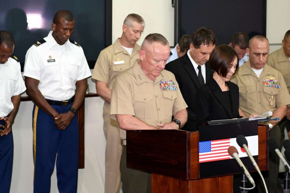 Lieutenant general Lawrence D. Nicholson (centre), Commander of the US Marine Forces in Japan, and others observe a moment of silence to mourn the death of a 20-year-old Japanese woman allegedly killed by a US military worker in May 2016. Photo: Kyodo