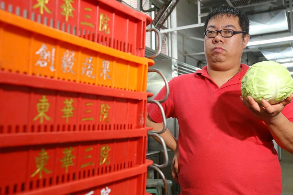 Lee Kwong-tak shows off a cabbage at the Jockey Club rehabilitation complex in Aberdeen. Photo: Edmond So