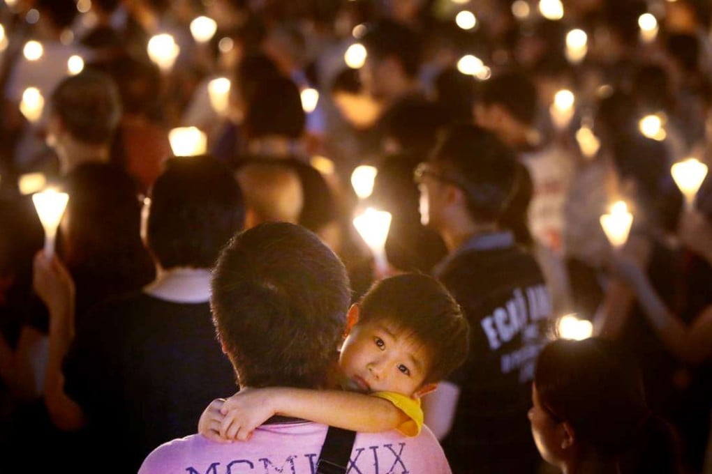 People hold up candles at the June 4 vigil to remember those who died in the Tiananmen crackdown in Beijing in 1989. Photo: Sam Tsang