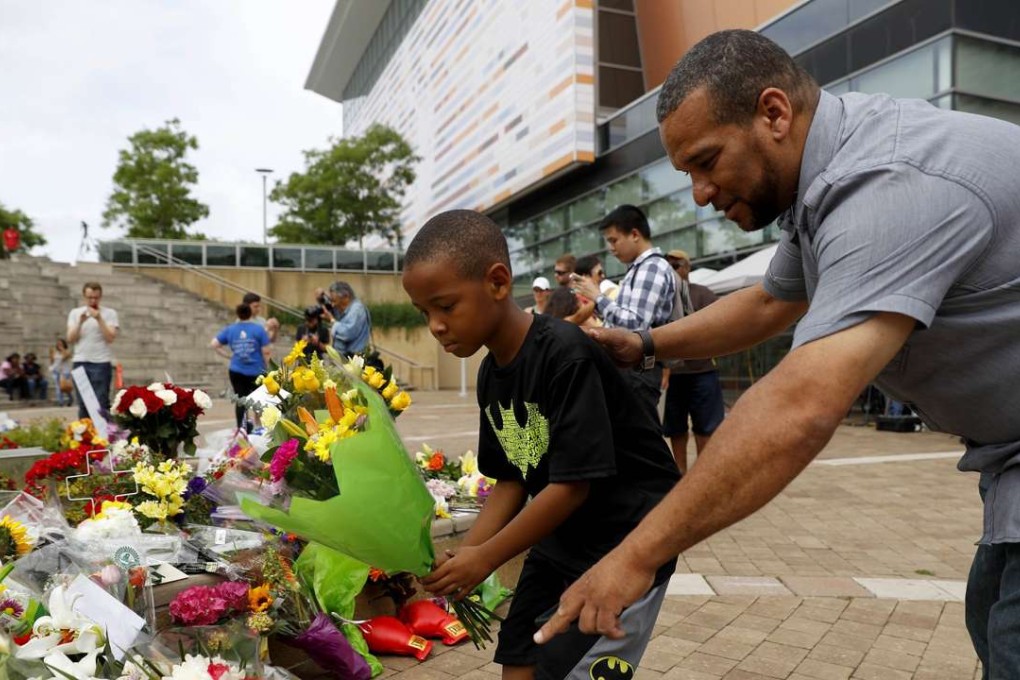 Mourners leave flowers at a memorial following the death of boxing legend Muhammad Ali. Photo: AFP