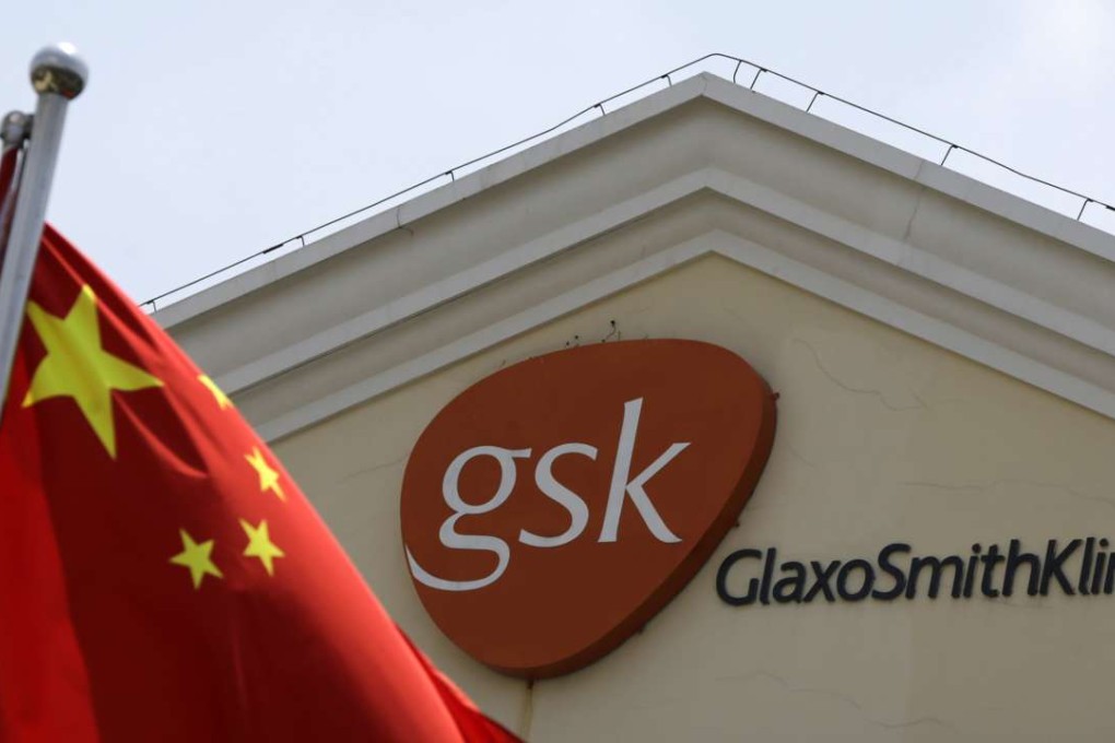 A Chinese national flag flies in front of a GlaxoSmithKline office building in Shanghai. GSK was fined a record 3 billion yuan for bribery in China in 2014. Photo: AP