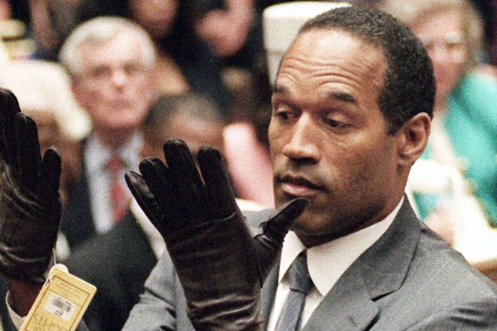 Simpson holds up his hands after putting on a pair of gloves similar to the infamous bloody gloves during his double-murder trial. Photo: AP