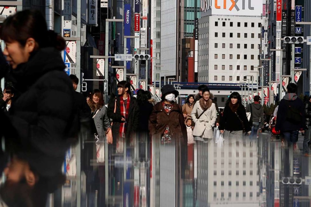 People walk on a street at Tokyo's Ginza shopping district. Photo: Reuters