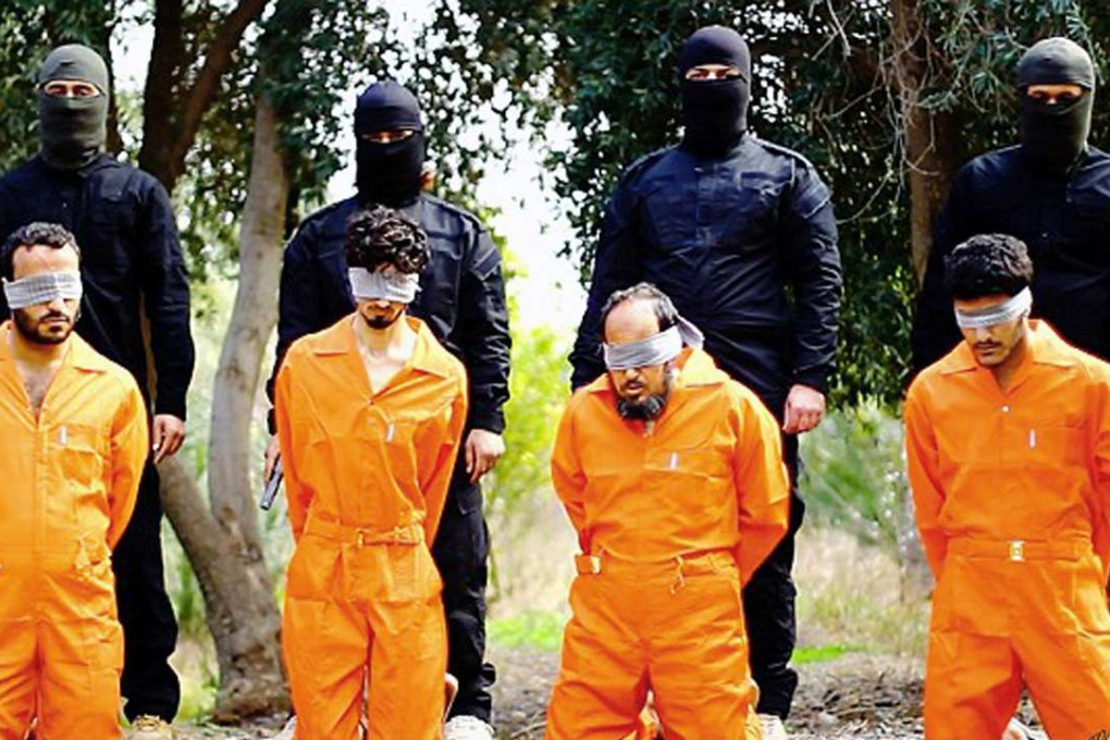 Members of the Islamic State group prepare to kill men who were allegedly spying for the US-led coalition in the province of Salah al-Din, Iraq, in an undated photo released on a militant website. Photo: AP