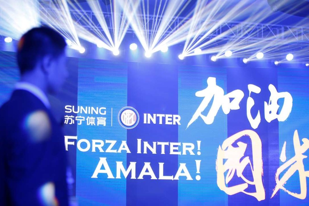 A security guard keeps watch before a news conference with Chinese retailer Suning and Italy's Inter Milan . Photo: Reuters