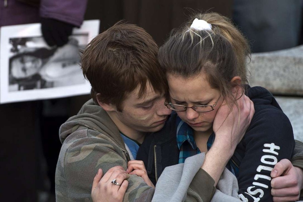 Friends embrace as several hundred people attend a community vigil to remember Rehtaeh Parsons at Victoria Park in Halifax, Nova Scotia, in 2013. Parsons’ family said she ended her own life after months of online bullying after she was allegedly sexually assaulted and a photo of the incident was distributed. Photo: AP