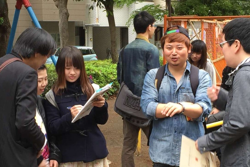 Chinese and Japanese people meet at a Hanyu Jiao (or Chinese chat) session at a park in Tokyo’s bustling Ikebukuro district. Photo: Kyodo
